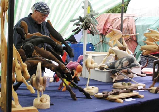 Pictured above is Paul Hempsall with his amazing wooden animals.