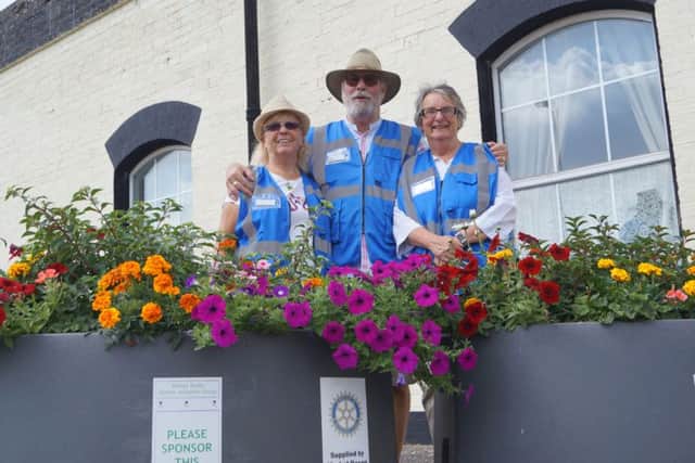 Volunteers with one of the many delightful floral tubs