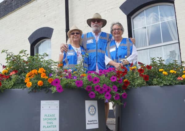 Volunteers with one of the many delightful floral tubs