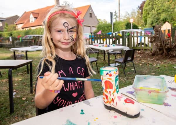 Lillyann Lees age 6 painting a wellie at the Duke of Wellington fun day. EMN-180409-120821001
