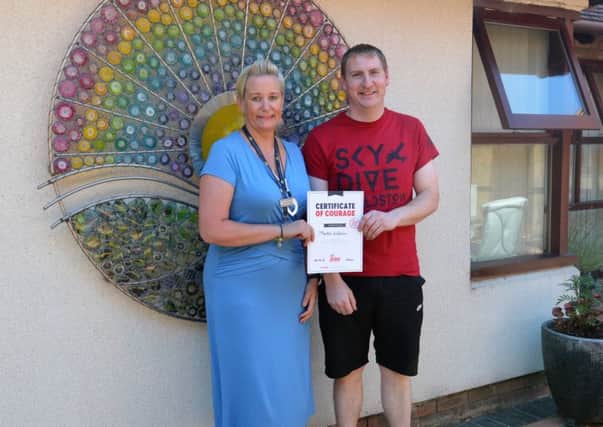 Skydiver Martin Watson is pictured with Sharon Tune of Lindsey Lodge Hospice. EMN-180509-172946001