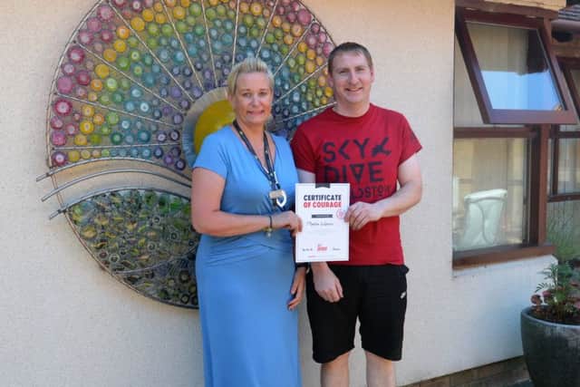 Skydiver Martin Watson is pictured with Sharon Tune of Lindsey Lodge Hospice. EMN-180509-172946001