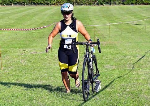 A Louth triathlete approaches the transition between the 22km cycle and 5km run finale EMN-180609-095018002