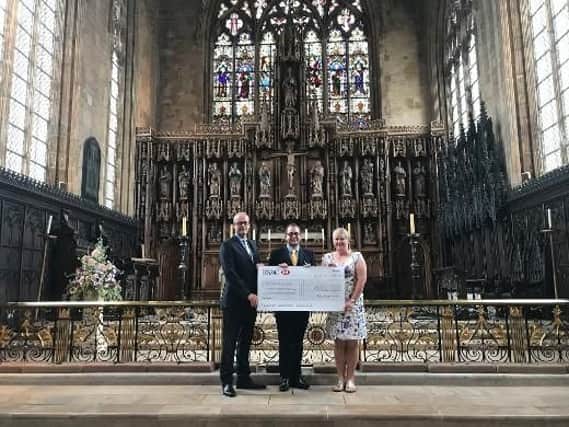 From left; Phil Drury, Chief Executive of Boston Borough Council hands over the 50,000 cheque to Adam Kelk, head verger at St Botolph's Church with Cllr Claire Rylott, Portfolio holder for tourism, arts, culture and heritage