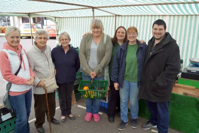 Lesley Danville, second right, with daughter Sue and son Ashley, plus just some of the customers who turned out to wish her well on her final day on Caistor market EMN-180917-094741001