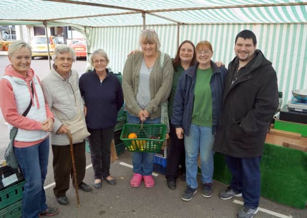 Lesley Danville, second right, with daughter Sue and son Ashley, plus just some of the customers who turned out to wish her well on her final day on Caistor market EMN-180917-094741001