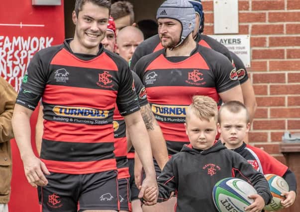 Mascots Nate Bennett and Jake Daniels walking out with club Captain Cory Stobart. Photo: Shaun Parkes (sparx photography). EMN-180913-173333001