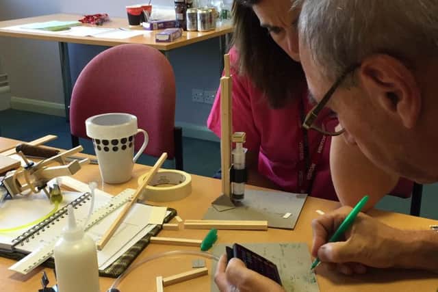 Two of the teachers work together to calculatethe
mathematical aspects of their structure