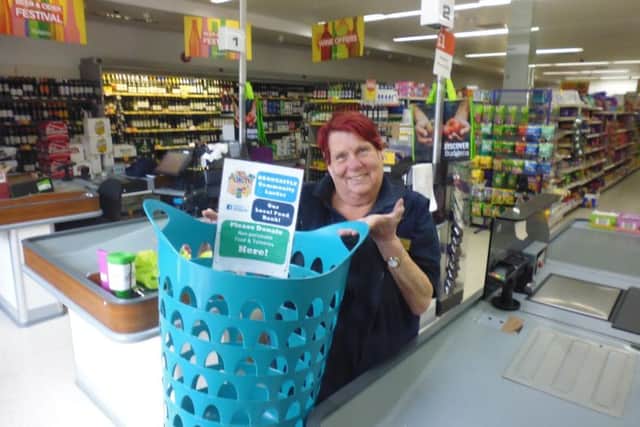 Jan Pierce, a member of staff at Budgens in Woodhall Spa, displays the new collection basket. Picture: Bob Wayne.