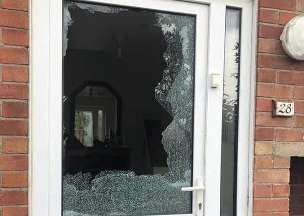 The shattered front door window