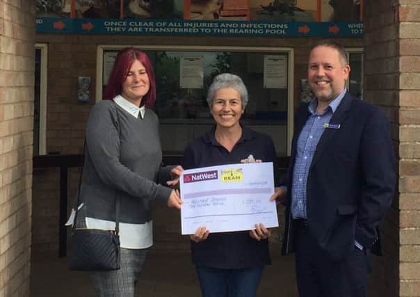 Geoff Short and Emma Latham from Beam Estate Agents presenting the cheque to Cheryl Yeadon (pictured centre) of Natureland ANL-180917-201008001