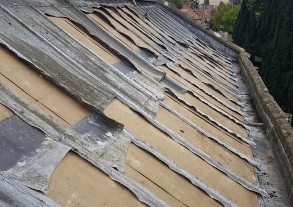 The roof at Wilsford Church with the remaining jagged strips of lower grade lead that were left behind by the thieves. EMN-180925-112955001