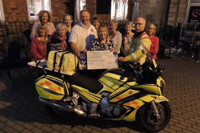 Sleaford Lionesses donate ?1,100 raised from their annual galf day to Lincolnshire Emergency Blood Bike Service. Past President Jackie Creedon is pictured with Adrian 'Smiler' Hutson - fleet manager and Charles Douse - deputy chairman of LEBBS presenting the money. EMN-180924-134523001
