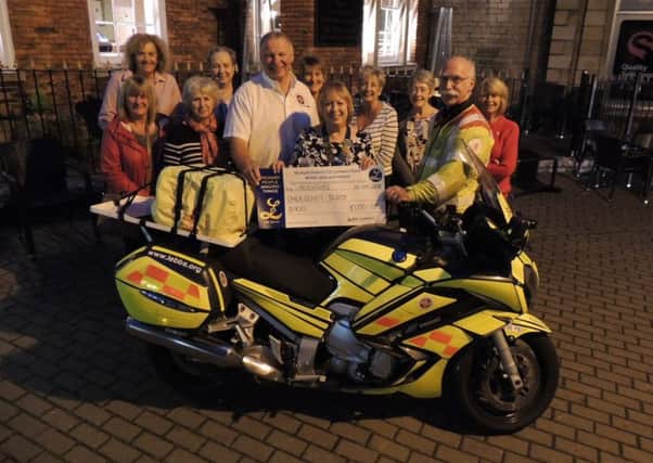 Sleaford Lionesses donate ?1,100 raised from their annual galf day to Lincolnshire Emergency Blood Bike Service. Past President Jackie Creedon is pictured with Adrian 'Smiler' Hutson - fleet manager and Charles Douse - deputy chairman of LEBBS presenting the money. EMN-180924-134523001