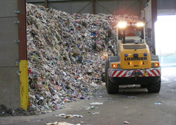 Mountains of recyclable waste waiting to be sorted at Mid Uk's plant. EMN-180919-095748001