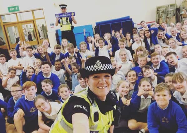 PC Mel Standbrook and PCSO Nigel Wass with pupils at Horncastle Primary School.
