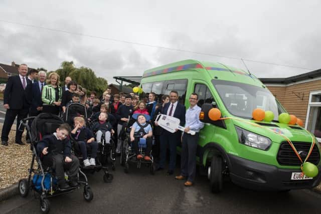 On behalf of Lord's Taverners Rory Underwood presents Boston's John Fielding Special School with a new bus. Rory, right, with headteacher Richard Gammon, representatives from Lord's Taverners and pupils from the school
Picture: Sarah Washbourn /www.yellowbellyphotos.com