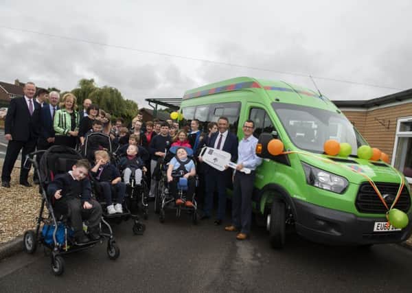 On behalf of Lord's Taverners Rory Underwood presents Boston's John Fielding Special School with a new bus. Rory, right, with headteacher Richard Gammon, representatives from Lord's Taverners and pupils from the school

Picture: Sarah Washbourn /www.yellowbellyphotos.com
