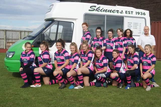 Pictured are this season's squad with their new strip.