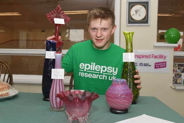 Epilepsy fundraising event at Horncastle Squash Club. Josh Inman with glass ware donated by Horncastle Glass Studio. EMN-180924-090656001