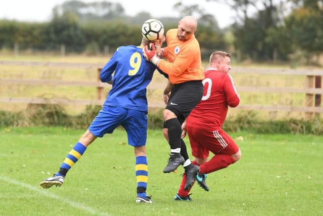 Carrington (blue) v Fishtoft (red). Neil Allen (blue), Darren Tate - Fishtoft goalkeeper.