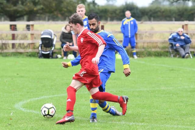 Carrington (blue) v Fishtoft (red). Junior Samra (blue), Kyle Tate (red).