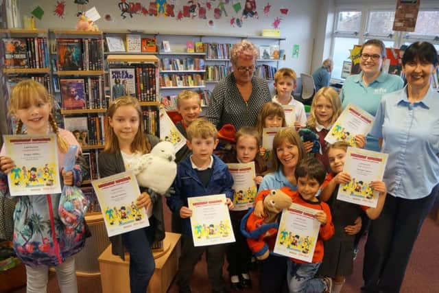 Some of the young readers who picked up their certificates for completing the Summer Reading Challenge EMN-180925-063624001