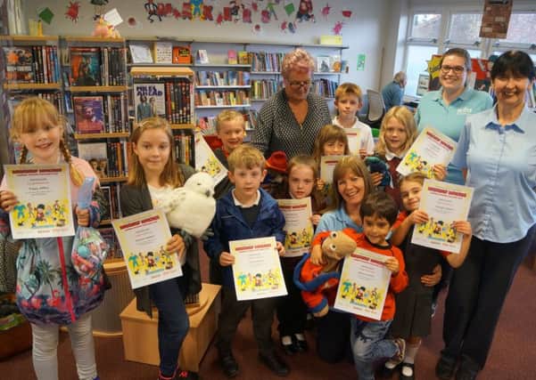 Some of the young readers who picked up their certificates for completing the Summer Reading Challenge EMN-180925-063624001