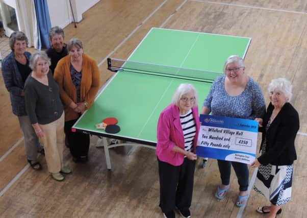 Chairman of Wilsford village hall committee, along with fellow committee members, receives a ?250 donation from secretary Rosie Smith and chairman Jo Leatherland of the Isaac Newton Lodge of the Oddfellows friendship group of Grantham. The money goes towards a new table tennis table and replacement upper windows for the hall, along with ?250 dontaed by the Tesco Bags for Life scheme. EMN-180920-172031001