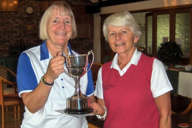Pam Hyde is presented with the Past Captain's Trophy by Lady Captain Janet Read