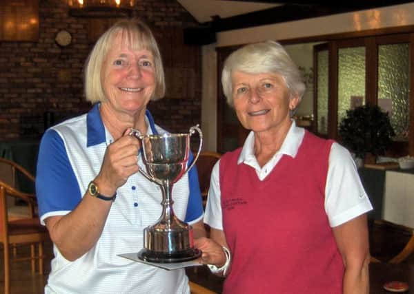 Pam Hyde is presented with the Past Captain's Trophy by Lady Captain Janet Read