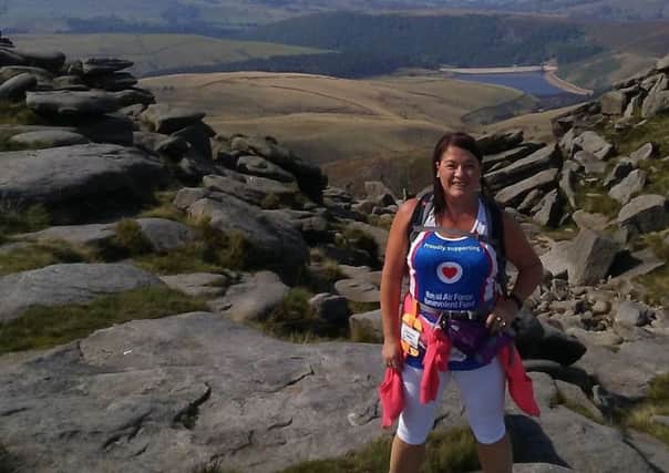 Maria Gordon pictured on the summit of Kinder Scout during her Trekfest challenge in the Peak District. Images supplied.