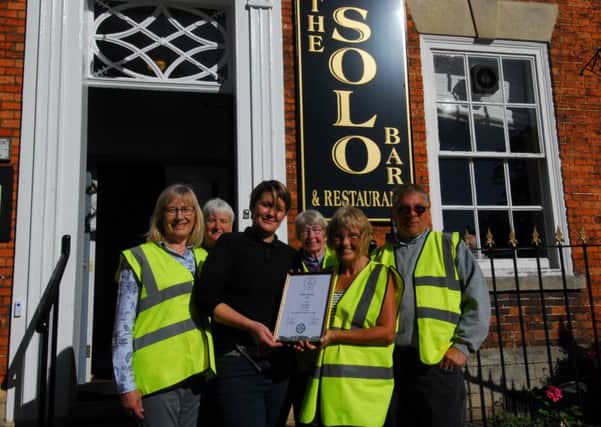 Sleaford In Bloom members present Sophie Hatcher of the Solo Bar with the East Midlands in Bloom silver award for best hotel and pub garden display. EMN-180928-093745001