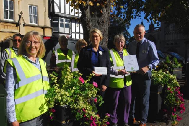 Sleaford In Bloom chairman Ada Trethewey with Tesco's community champion Lesley Sargeant and store manager Steve Ross with some of the planters in the Market Place that the store's Bags of Help scheme has funded with an over £3,000 grant. They received a special judges award from East Midlands in Bloom for the installation. Also pictured are, from left - Rodney Maddison, Becky Mayfield, Linden Bailey and Penny Borrill. EMN-180928-094926001