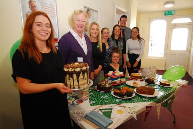 Showing off her amazing Malteser cake, Vicki Laight and fellwo staff at Ringrose Law in Sleaford on Macmillan Coffee Morning. EMN-180110-124809001