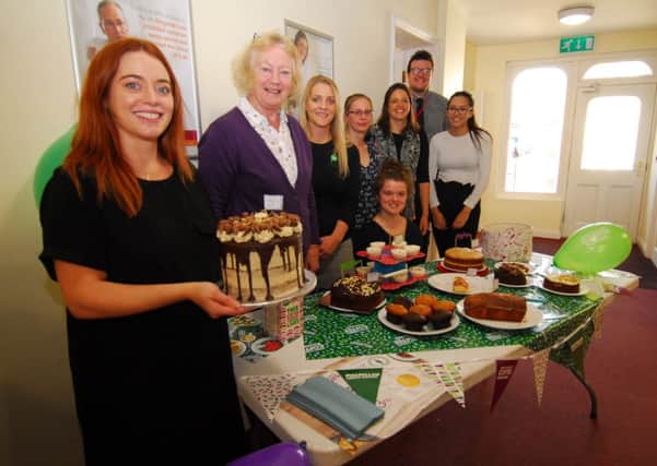 Showing off her amazing Malteser cake, Vicki Laight and fellwo staff at Ringrose Law in Sleaford on Macmillan Coffee Morning. EMN-180110-124809001