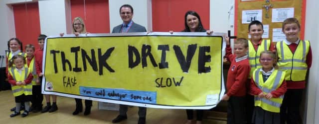 Think fast: drive slow! The message on the winning banner presented to delighted pupils and staff at Coningsbys St Michaels Church of England Primary School.
Wilkin Chapman Partner Steve Hennegan was joined at the school by Alison Garfoot (left) from the Road Safety Partnership and Faye Nam from the air ambulance. EMN-180210-161045001