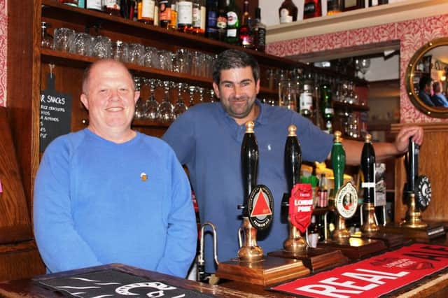 CAMRA branch chairman Jerry Gale with Brown Cow landlord Nigel Hopper.