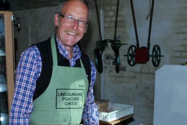 Committee member Rob Price, ready to slice cheese at the Burgh le Marsh Heritage Group Lincolnshire Poacher cheese and chine event.
