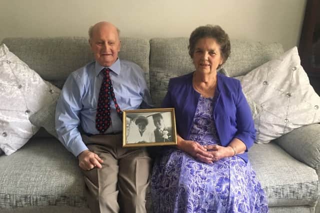 George and Hilda Mason pictured at their home in Horncastle holding their wedding picture from 60 years ago. EMN-180810-105448001