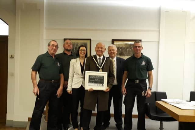 Mayor of Skegness Coun Sid Dennis (centre) with the silver prize won in the Medium Cemetery Category at the National Cemetery of the Year awards and the team who run St Mary's Cemetery in Winthorpe. ANL-180410-142921001