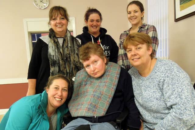 Rebecca with her support team, including Mary Cottingham, right, who has been with Rebecca for many years.