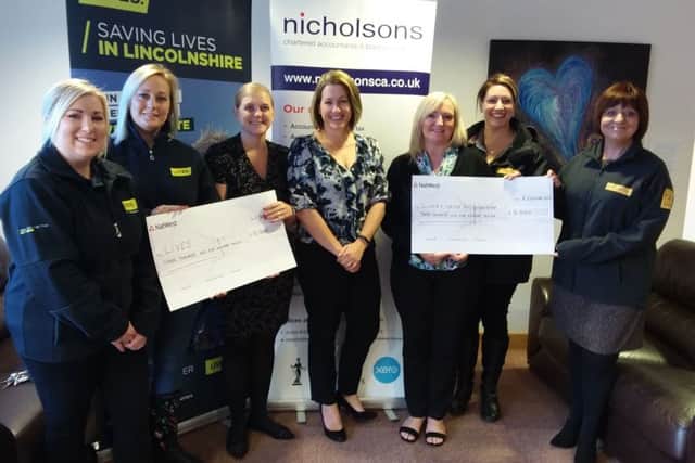 Representatives from LIVES and the Lincs & Notts Air Ambulance collect their cheques from Nicholsons Chartered Accountants EMN-180910-141024001