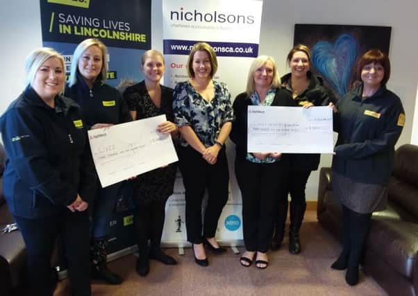 Representatives from LIVES and the Lincs & Notts Air Ambulance collect their cheques from Nicholsons Chartered Accountants EMN-180910-141024001