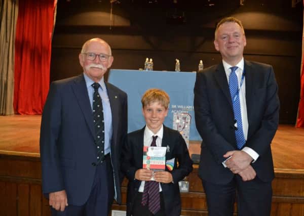 Kevin Lawry, pupil Freddie Street who won the boys' PE Achievement Award, and Mark Guest. Image supplied.