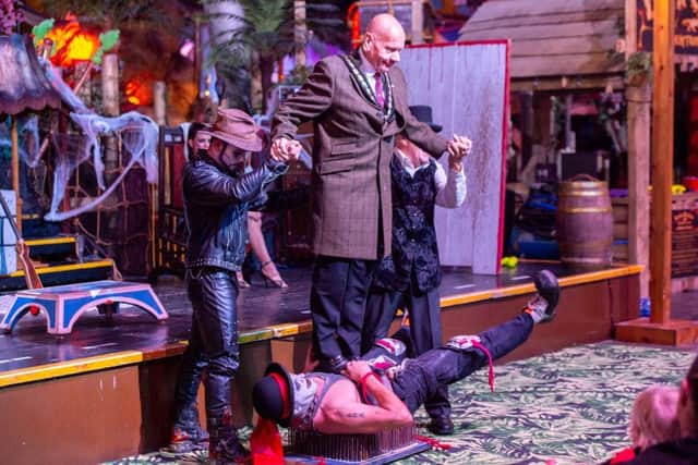 He nailed it! Mayor Coun Sid Dennis walks over Circus of Screams clown Mr Fips. Photo: John Aron. ANL-181015-100010001