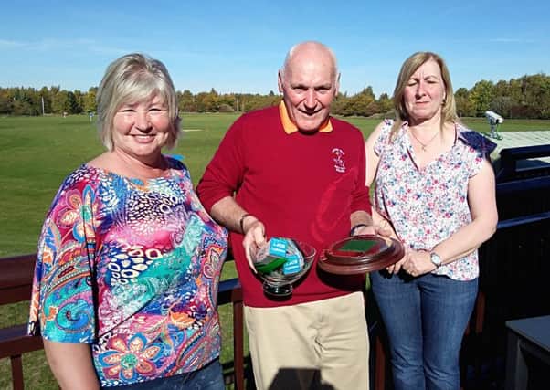 Tony Taylor is pictured receiving the Tony Snell Memorial Trophy from Tony's daughters Sandra Reedman and Jane Hodgson.