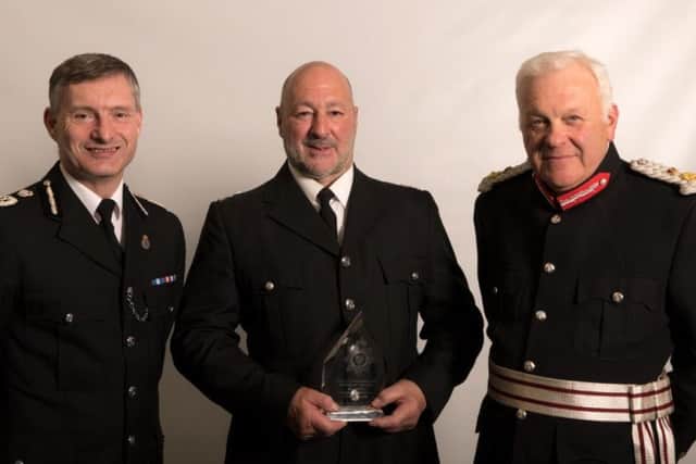 Special Constable Nick Lamb receives his officer of teh year award from Chief Constable Bill Skelly and Lord Lieutenant of Lincolnshire Toby Dennis. EMN-181110-171057001