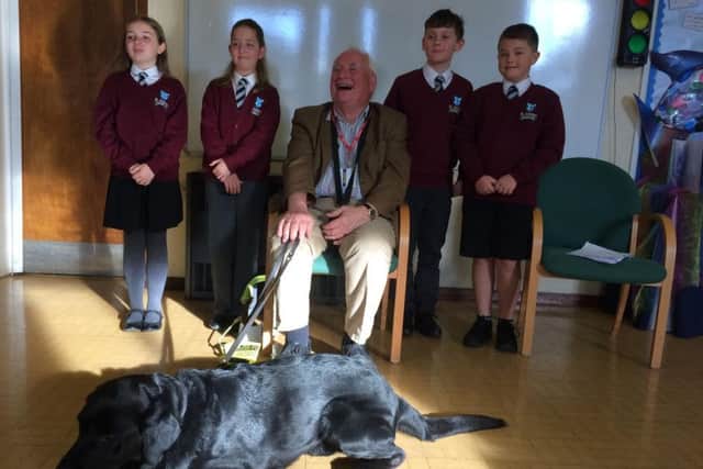 Keith Kelsey and his guide dog visited pupils at St Andrew's Primary School. EMN-181015-145854001