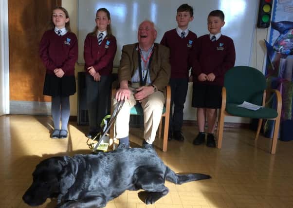 Keith Kelsey and his guide dog visited pupils at St Andrew's Primary School. EMN-181015-145854001